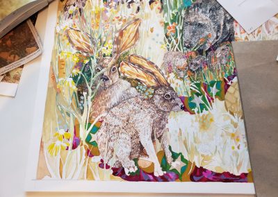 The bottom left corner of the Al Tucci commissioned art piece titled "The Dorothy Project." There are two rabbits and a mother Javelina with 4 little babies along with wildflowers.